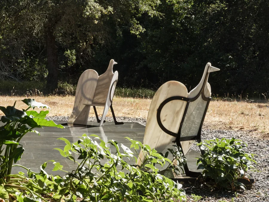 Christie's, Anthology of Design: dos asientos de mármol con forma de pájaro y estructura de metal negro al aire libre
